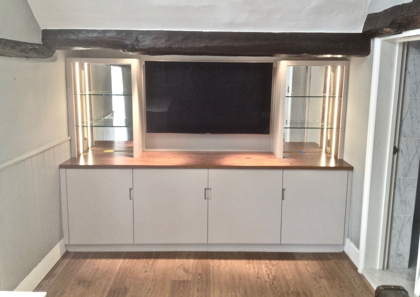 Bespoke media unit with oak top and lit mirrored display