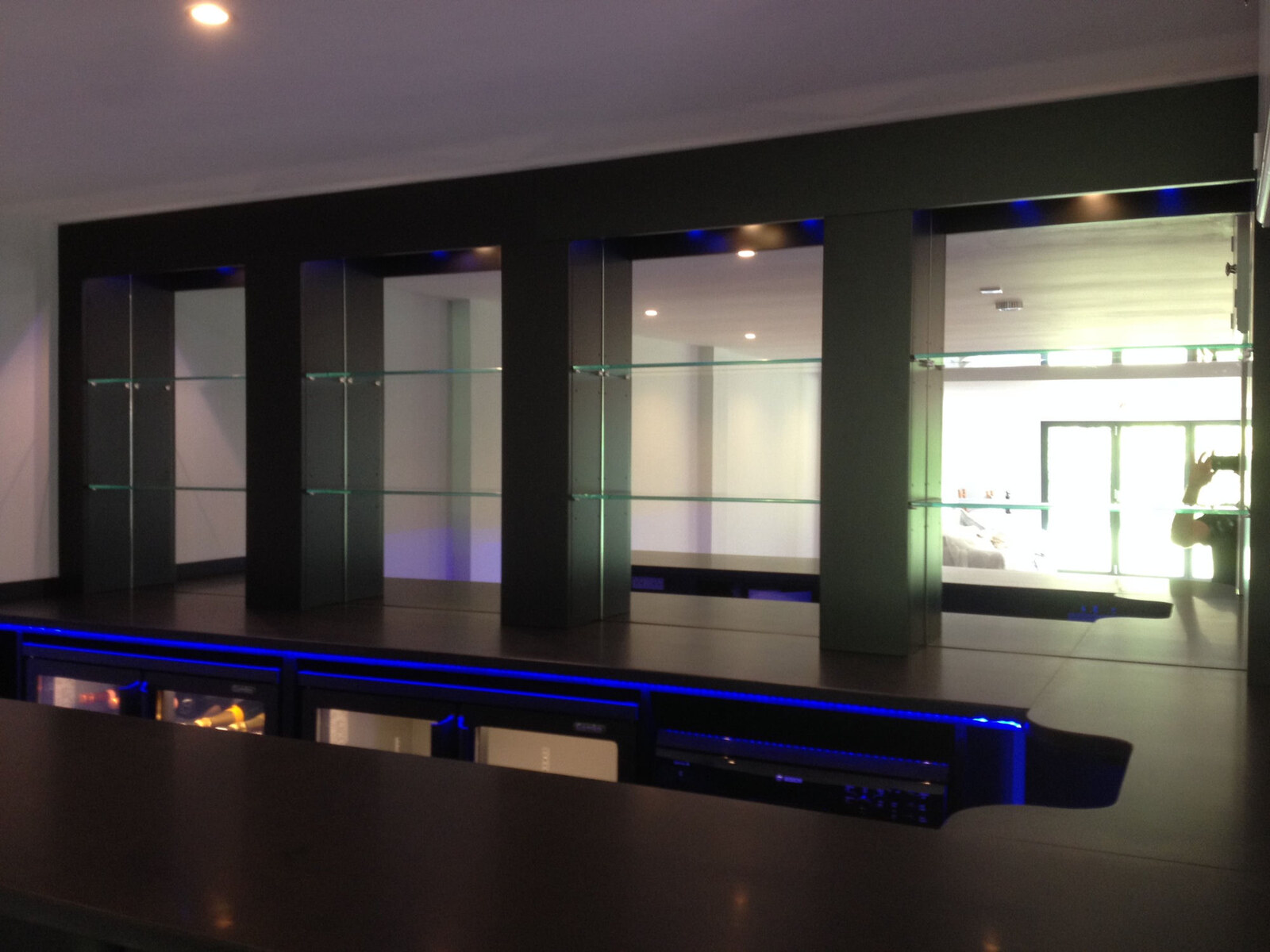 Dark media unit with glass shelves and blue LED accent