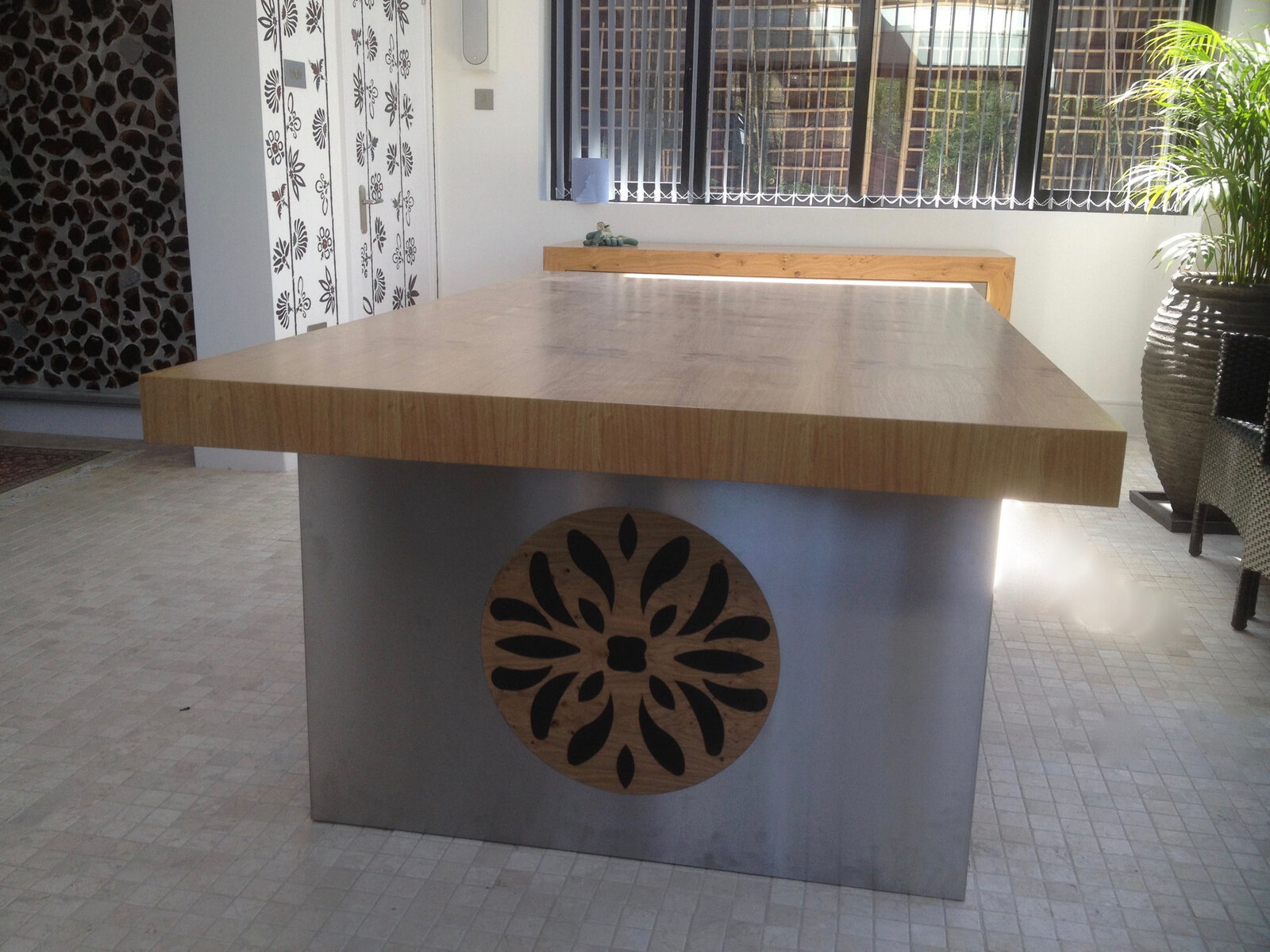 Bespoke oak dining table on brushed steel base with floral cut-out inlay